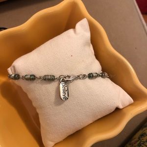 8” silver bracelet. Green stone and a charm.